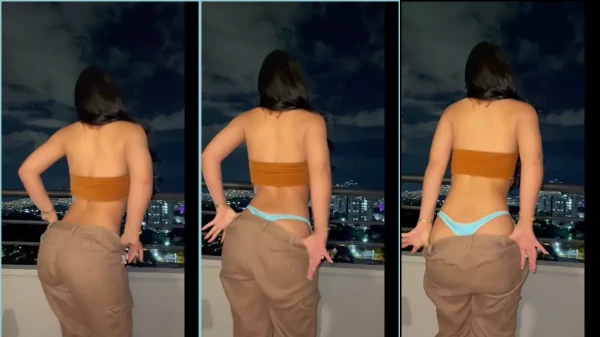 Cata Gonzalez fazendo um strip delícia na varanda do apê